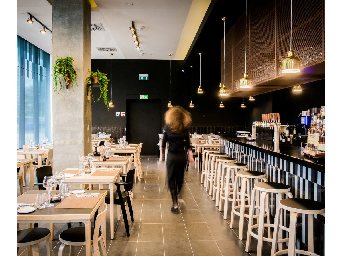 Artek 64 Bar Stool - Lifestyle shot in a restaurant