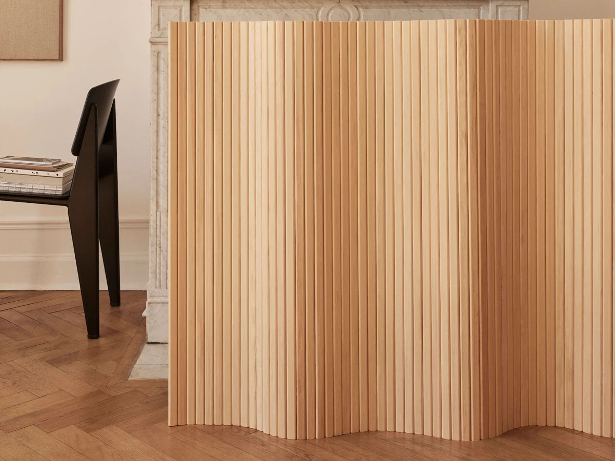 Artek Screen 100 - Wooden room divider in a room with a chair and table.