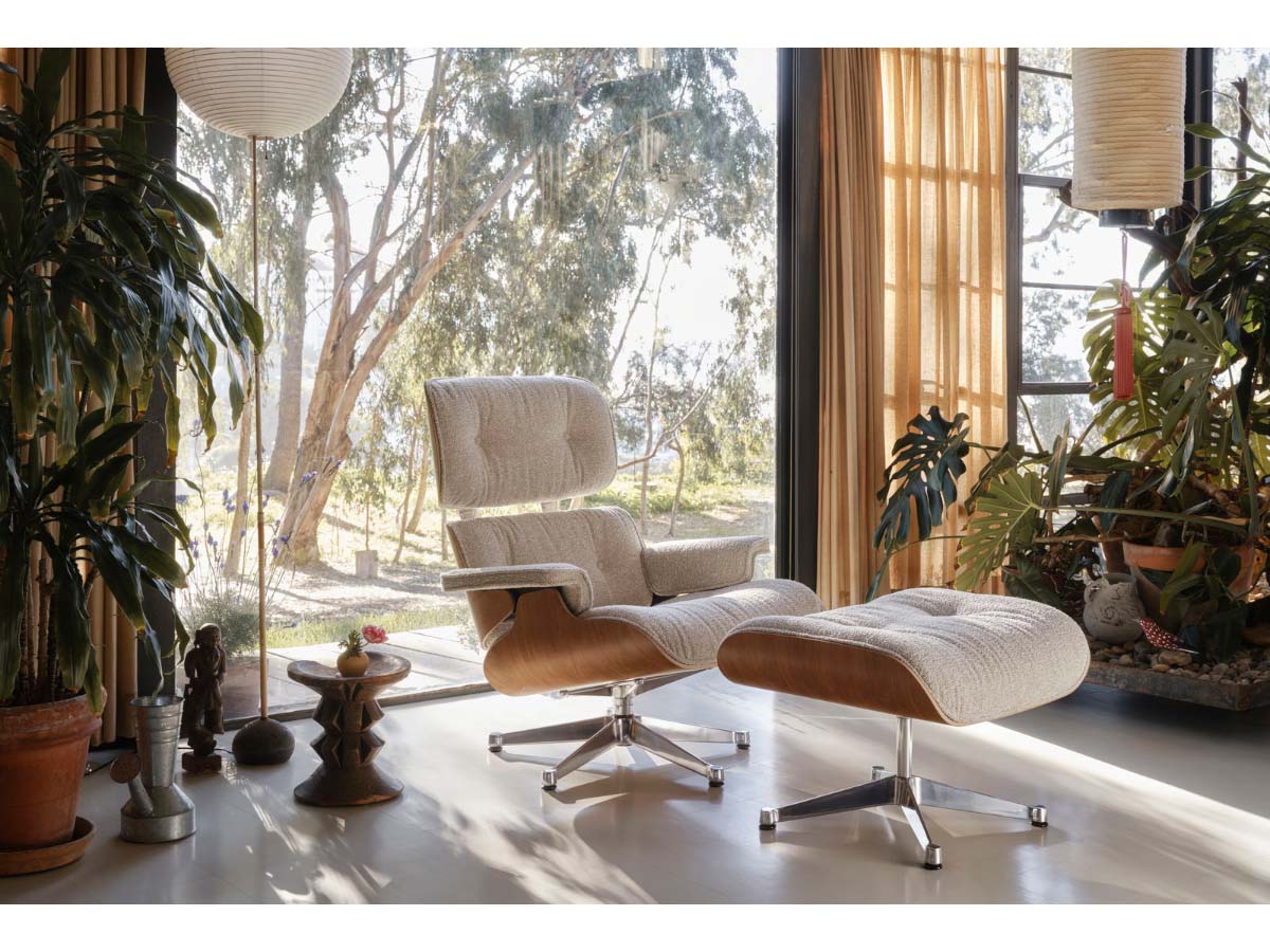 Vitra Eames Lounge Chair & Ottoman in fabric upholstery, featuring a wooden frame and a cushioned seat and backrest.