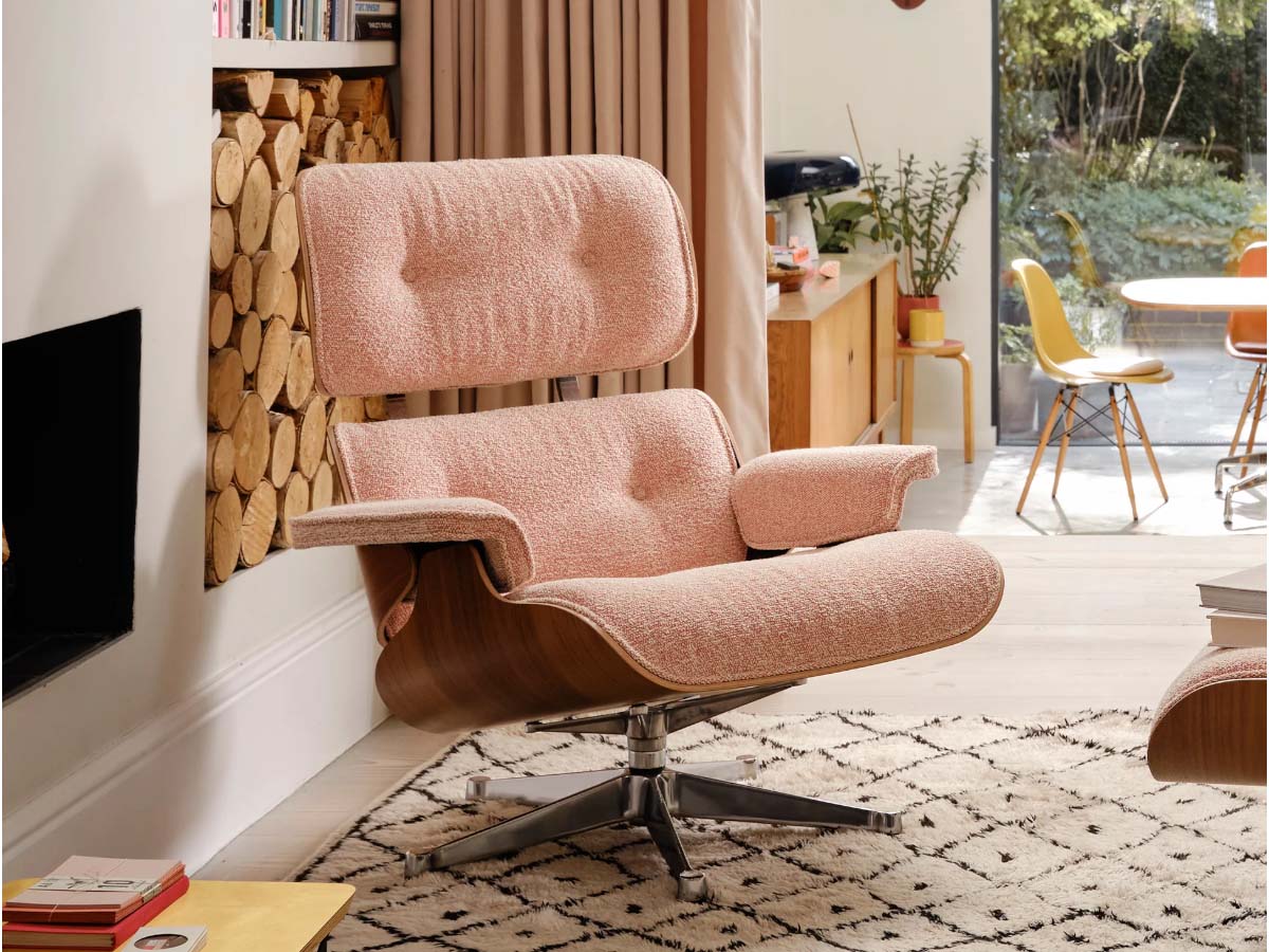 Vitra Eames Lounge Chair & Ottoman in fabric upholstery, featuring a wooden frame and a cushioned seat and backrest.