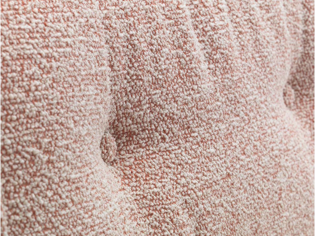 close up of detail of pink nubia fabric eames xl lounge chair
