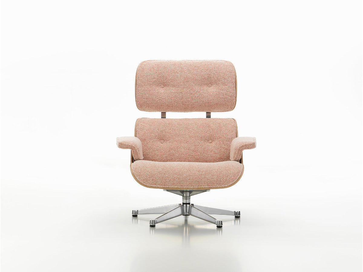 A pink upholstered Vitra Eames Lounge Chair XL with a rosewood frame and a cushioned seat and backrest.