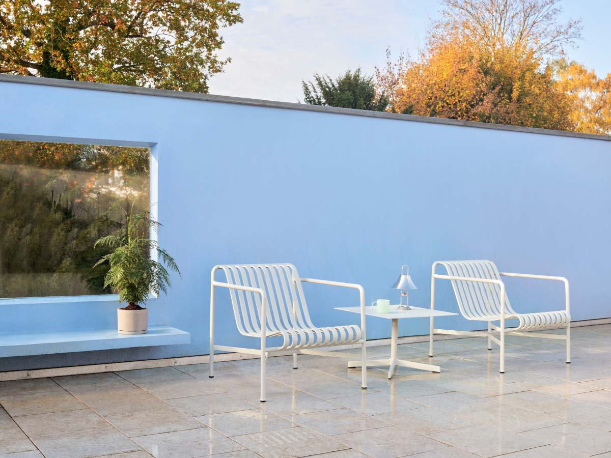 hay palissade lounge chair low cream against blue wall